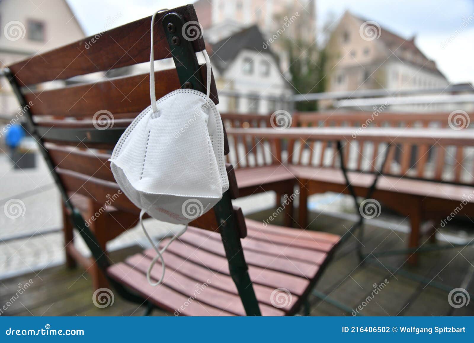 corona crisis - lockdown - ffp2 mask hangs on a chair in an empty beer garden in steyr, austria, europe