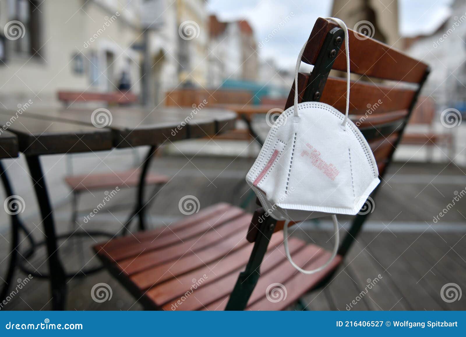 corona crisis - lockdown - ffp2 mask hangs on a chair in an empty beer garden in steyr, austria, europe