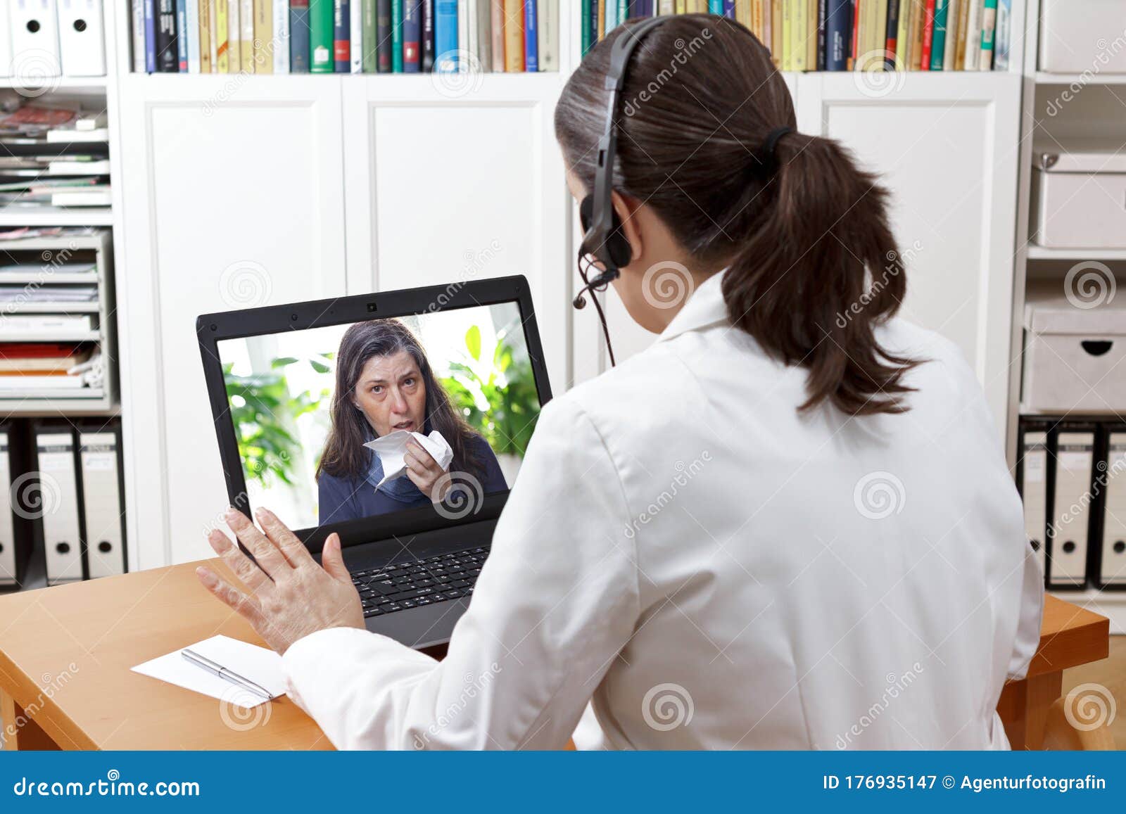 telemedicine concept: doctor during a video consult with a coughing patient.