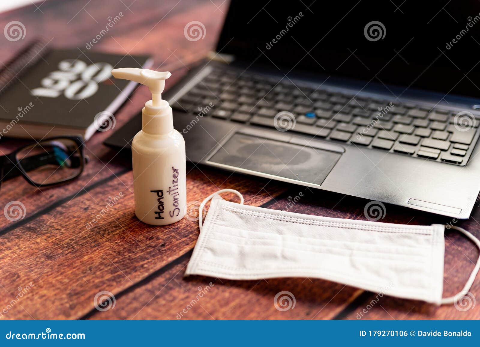 corona virus, work from home kit on wooden office desk with hand sanitizer and face mask, a solution against the outbreak of covid