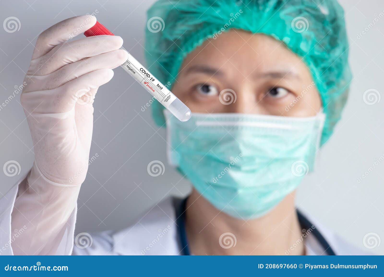 coronavirus covid-19 test concept. doctor`s hand with glove holding test tube with patient nasal secretion sample for covid virus