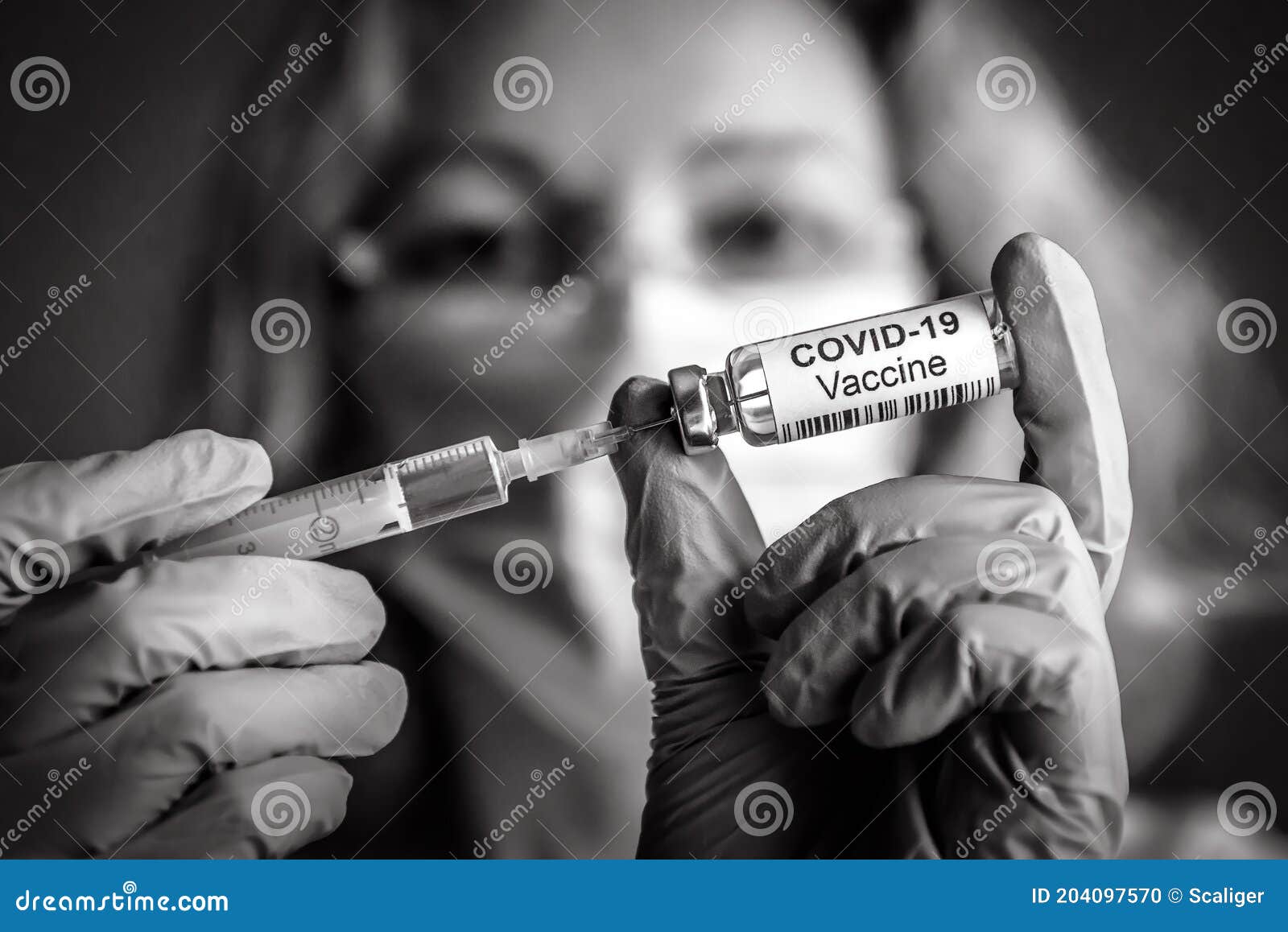 coronavirus vaccine bottle and syringe in doctorÃ¢â¬â¢s hands
