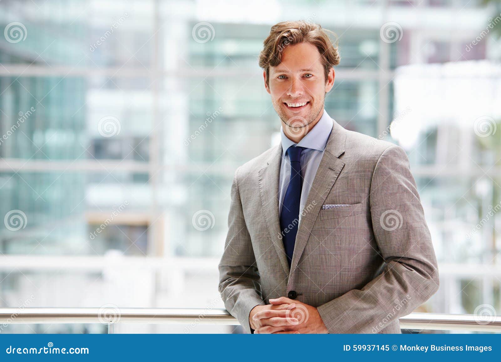 corporate businessman in modern interior, waist up portrait