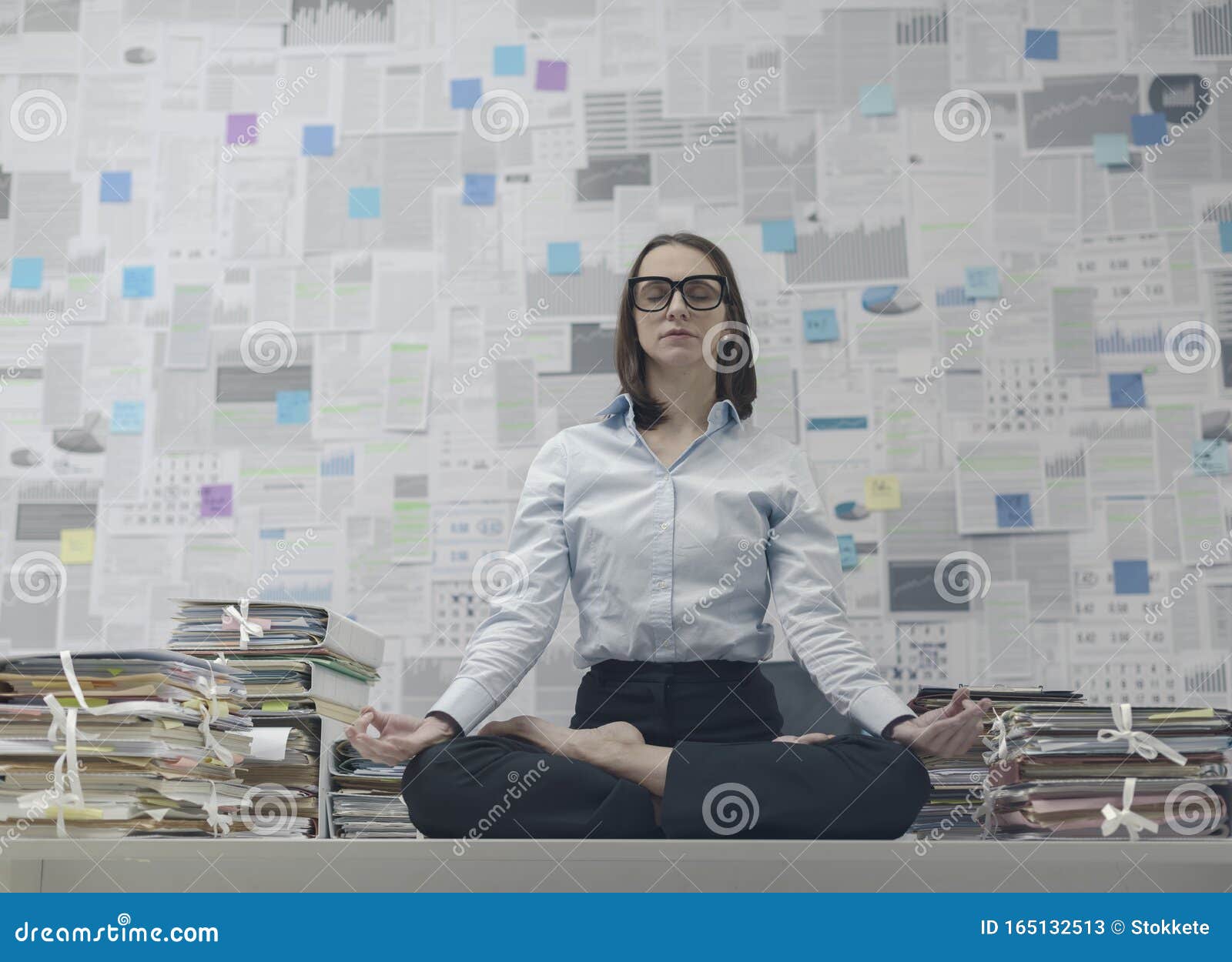 Corporate Businesswoman Practicing Meditation In The Office Stock