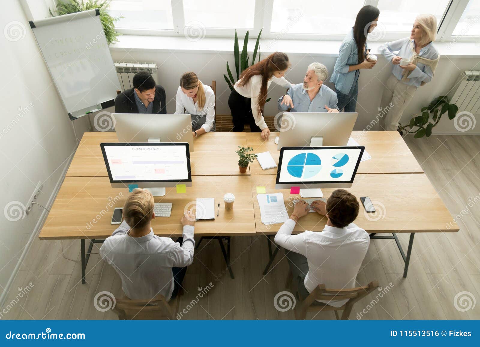 corporate staff working in office together using computers and t