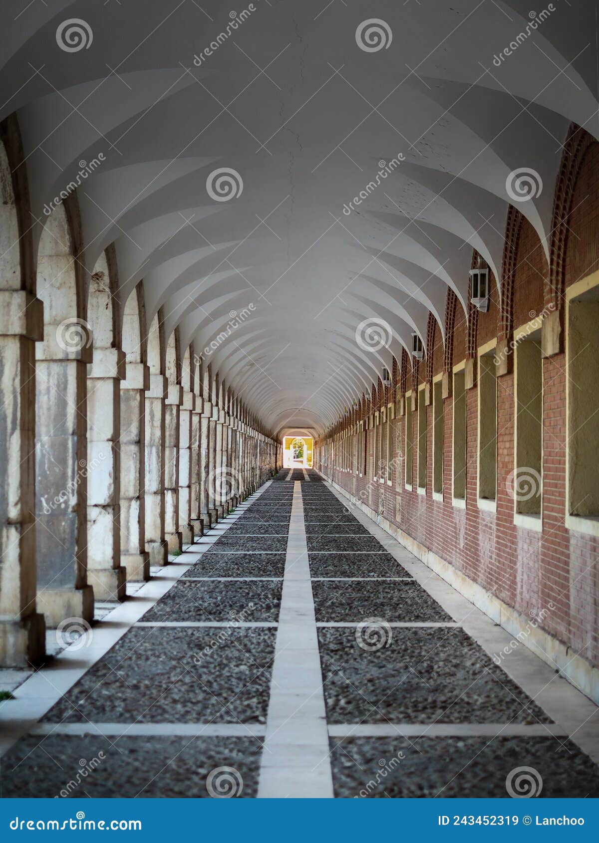 corridor with columns and arches that form a tunnel. casa de los ninos in aranjuez. path around the sumptuous building, edited