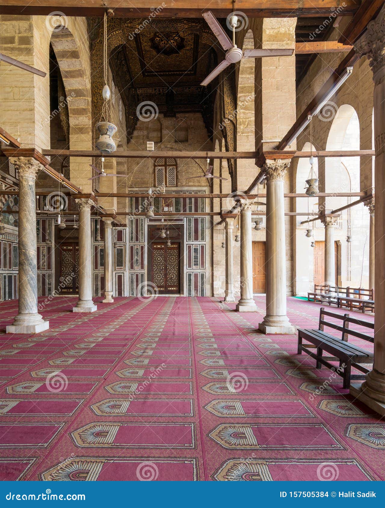 corridor at mosque of sultan moaayad, ending with colorful marble wall and wooden door, cairo, egypt