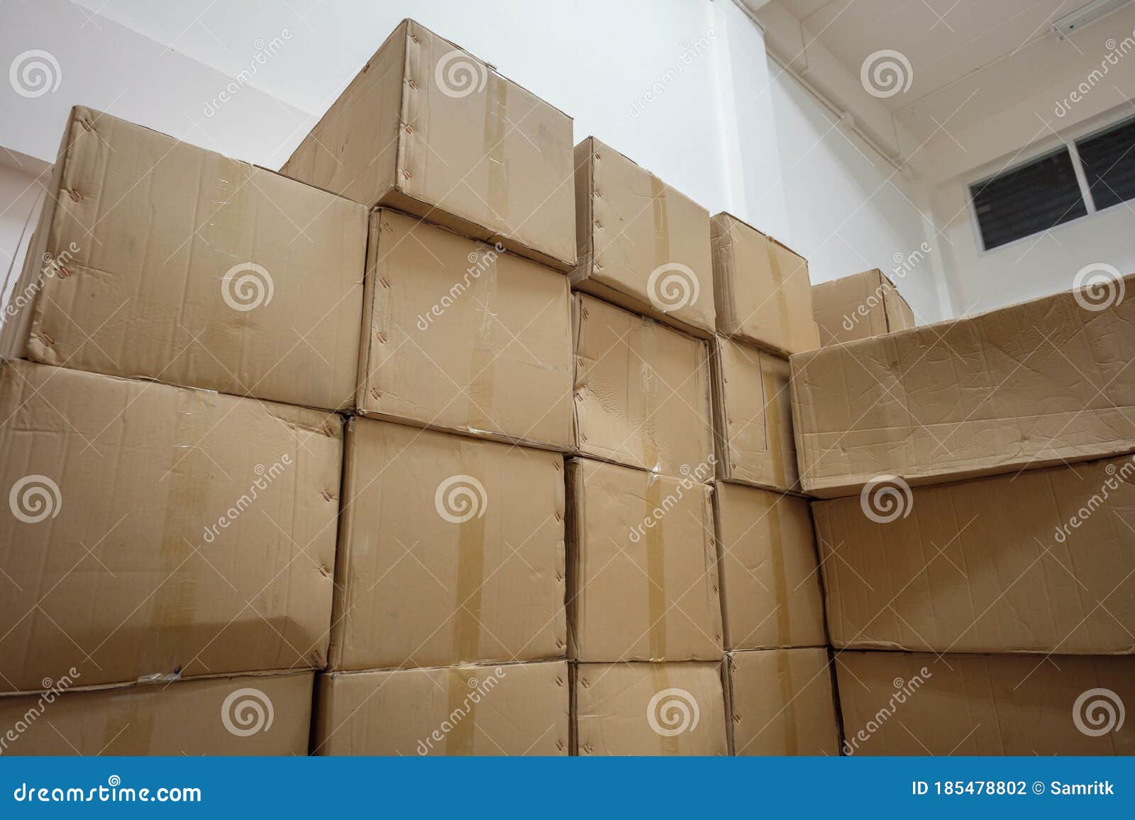 Corrugated Cardboard Storage Boxes Stacked in Warehouse Stock Photo