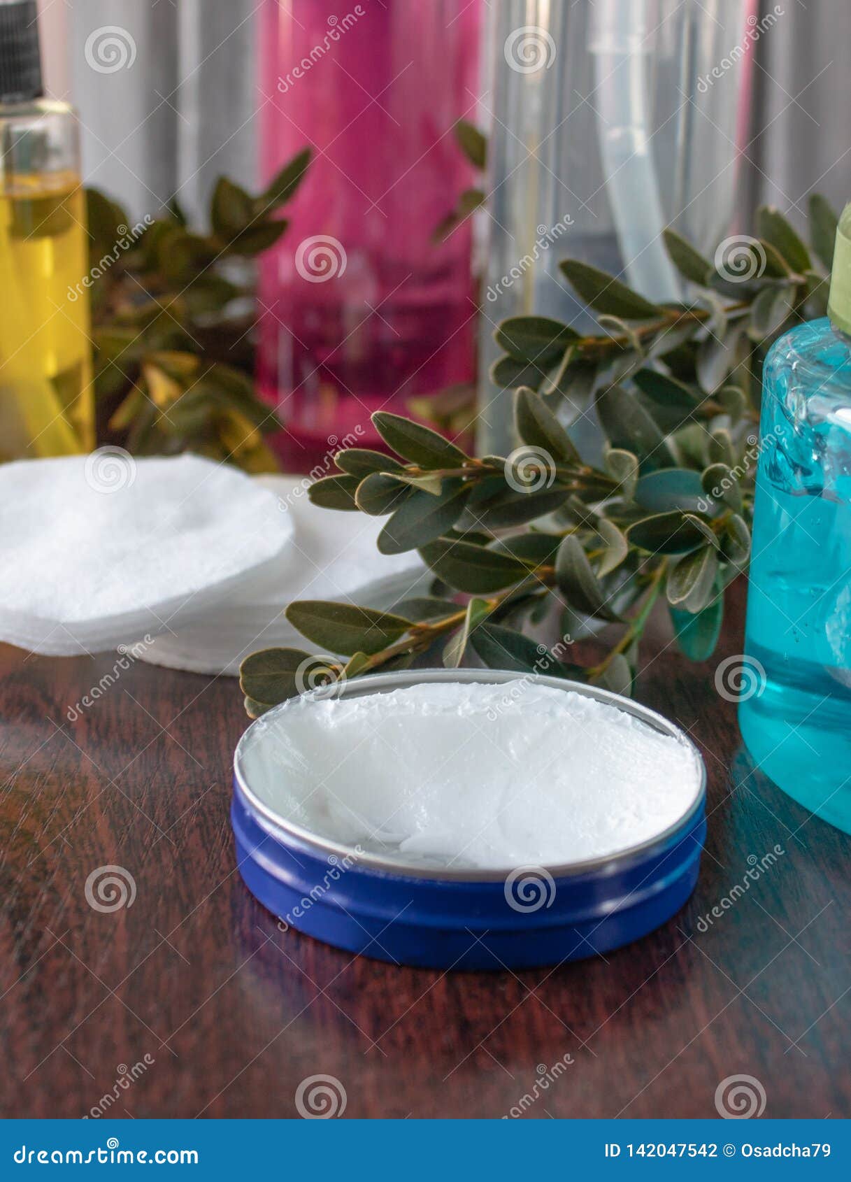 Cosmetic Accessories on a Dark Background, White Cream in a Blue Jar