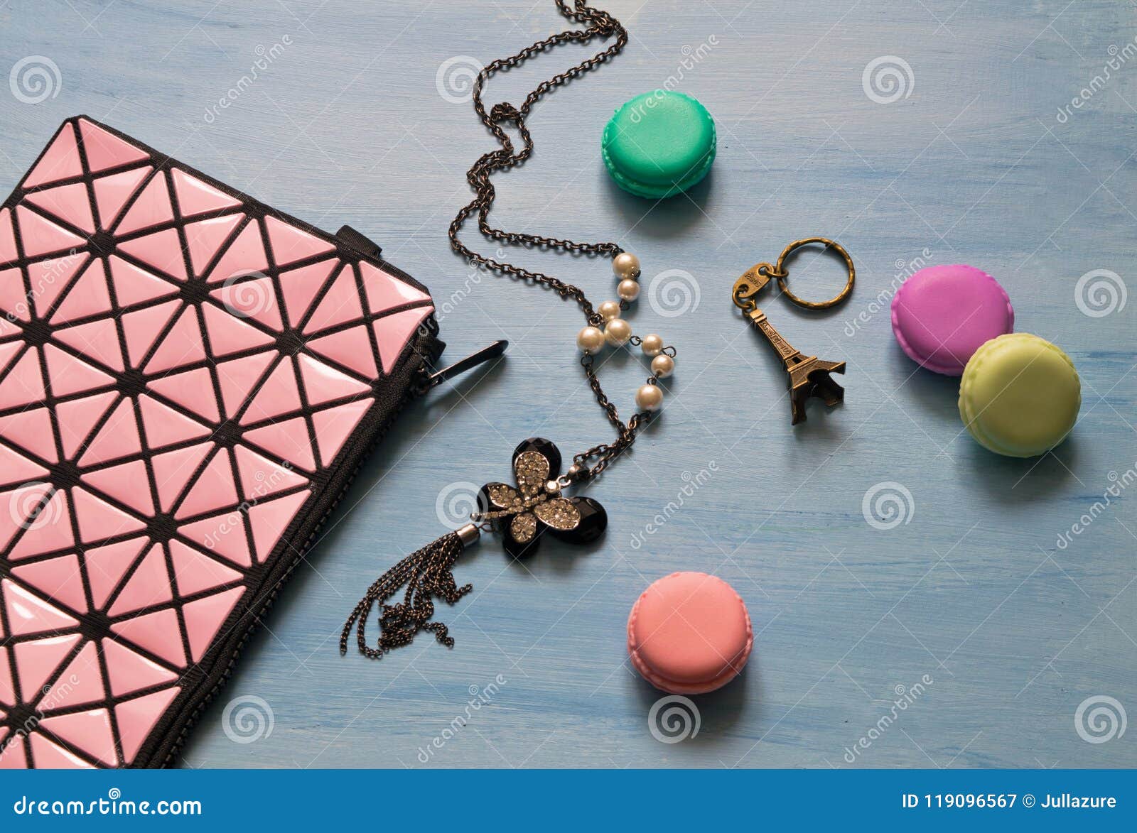 Cosmetic Bag, Decoration, Key Chain and Macaroons on Blue Background