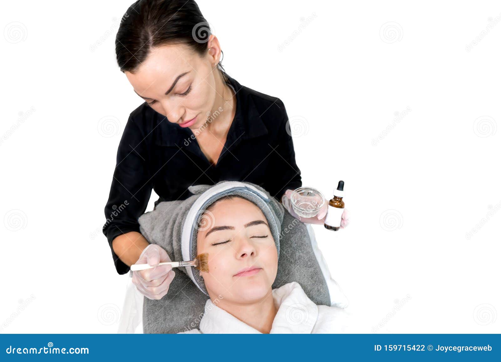 Cosmetologist Administering Chemical Peel Treatment On Patient In A