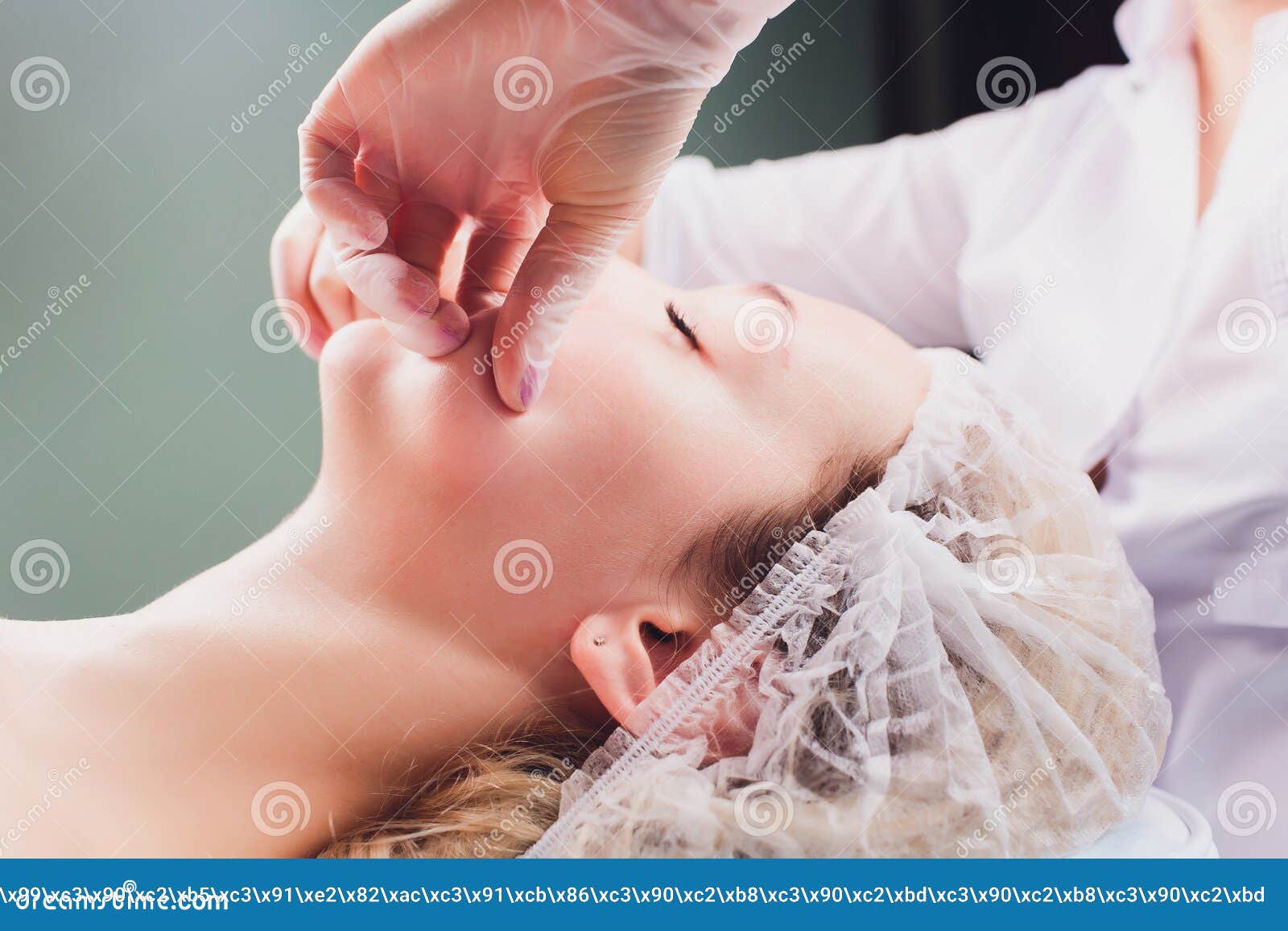 Cosmetologist Makes A Buccal Massage Of The Patient`s Facial Muscles