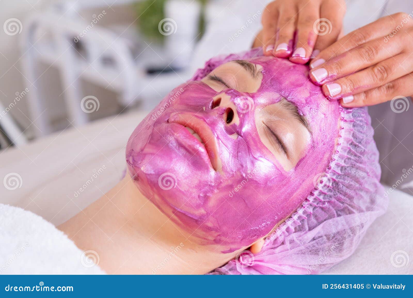 Cosmetologist Making Massage The Skin Of The Forehead Woman In A Spa Salon On Cosmetic