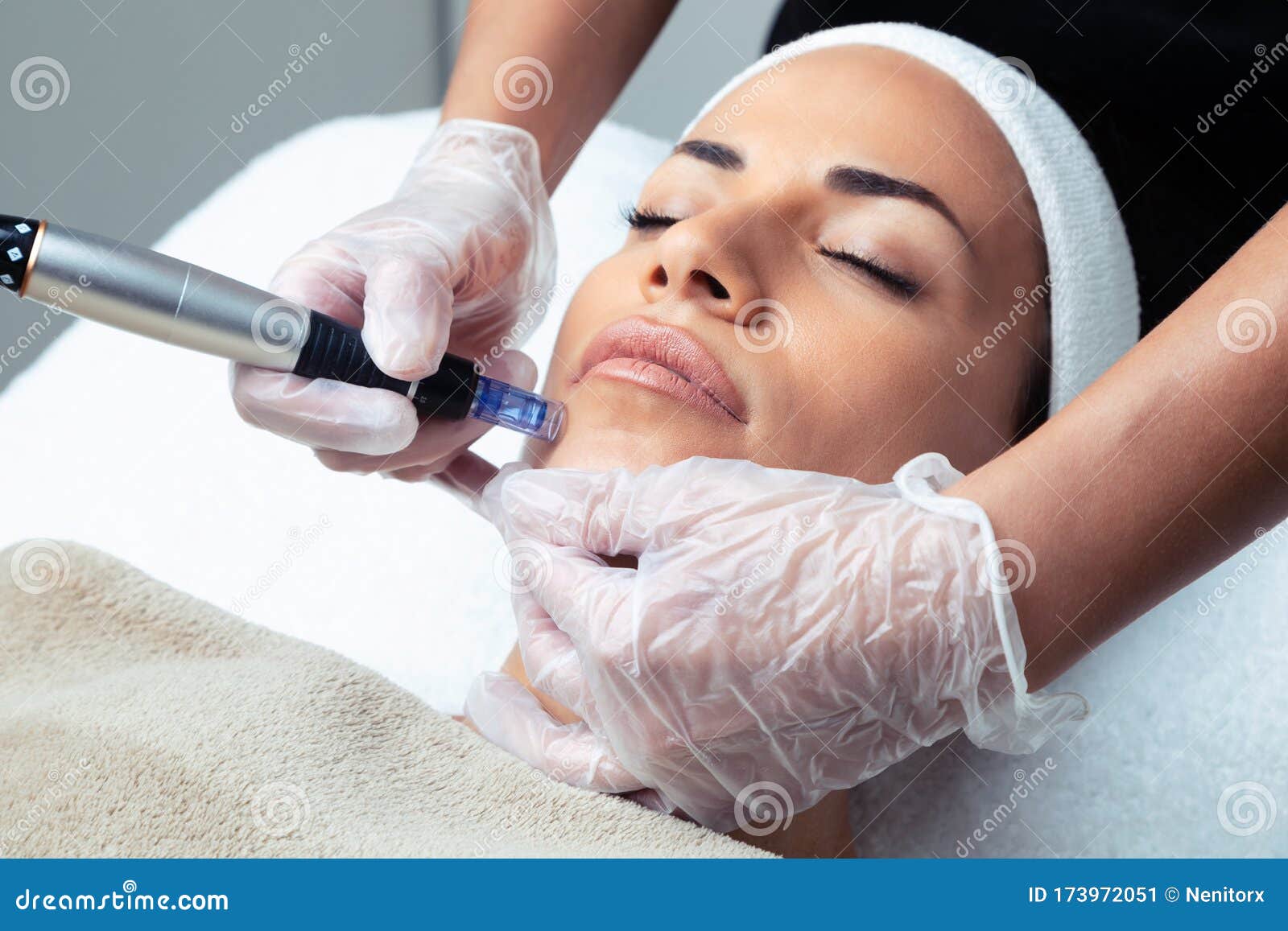 cosmetologist making mesotherapy injection with dermapen on face for rejuvenation on the spa center
