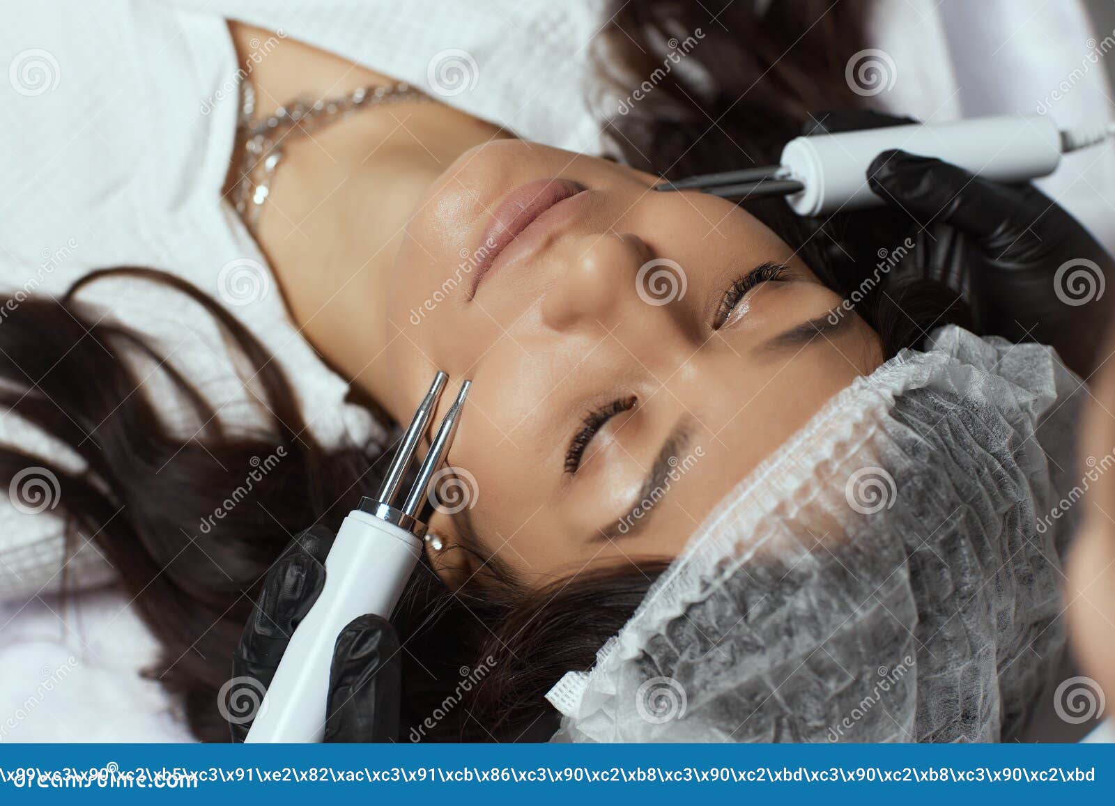 Cosmetology Beautiful Woman At Spa Clinic Receiving Stimulating Electric Facial Treatment From