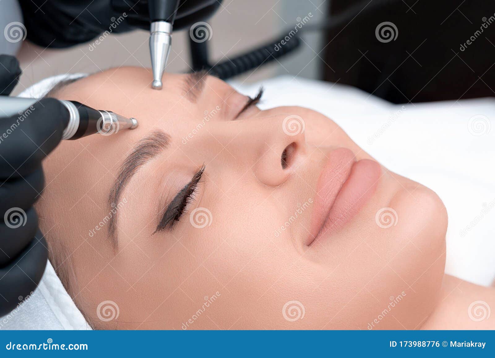 Cosmetology Beautiful Woman At Spa Clinic Receiving Stimulating Electric Facial Treatment From