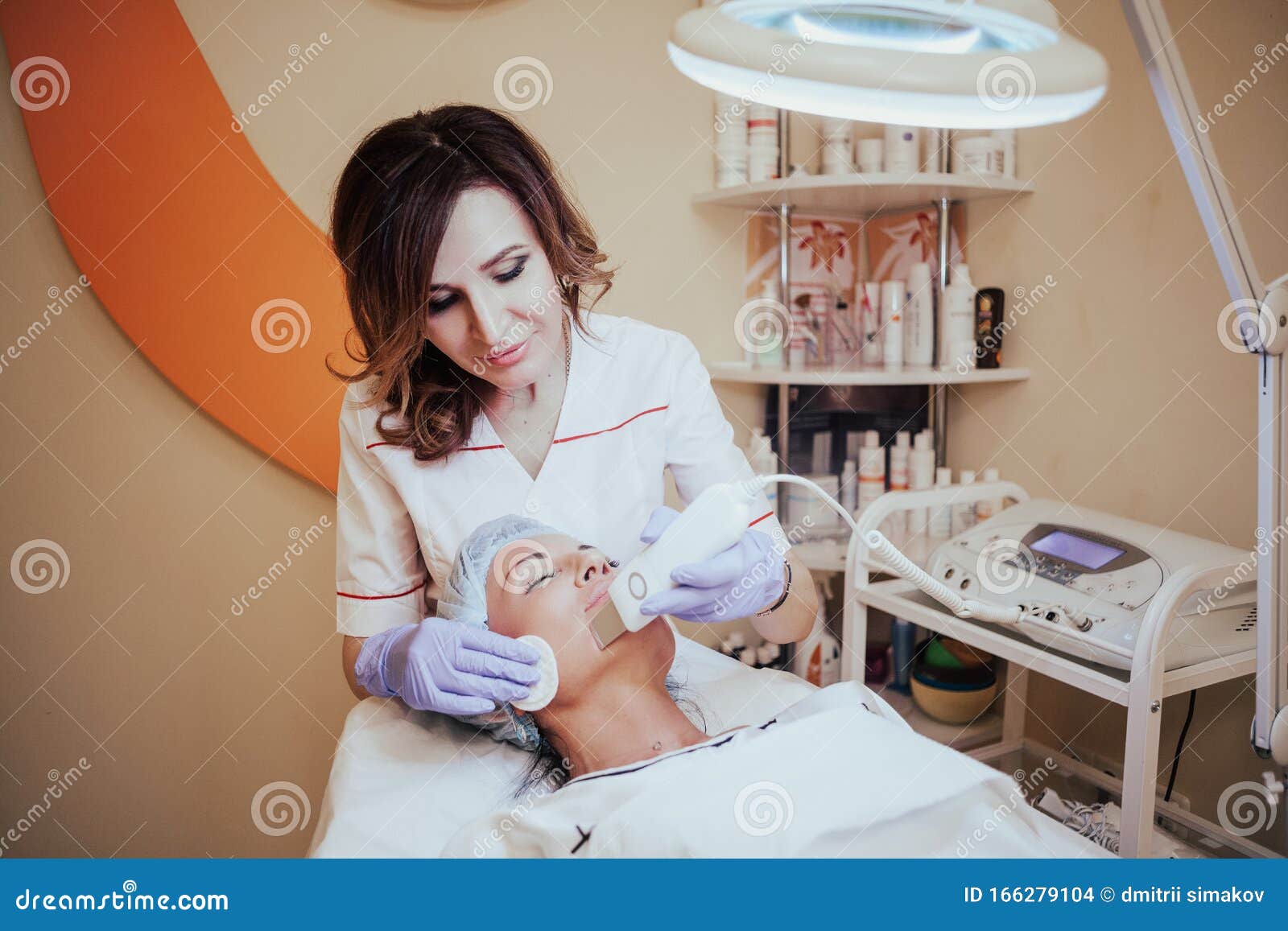 Cosmetology Doctor Makes The Procedure A Woman Face Cleaning Stock