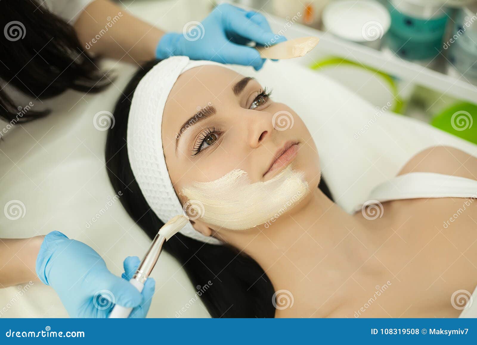 woman receiving professional brush peeling in the cosmetology of