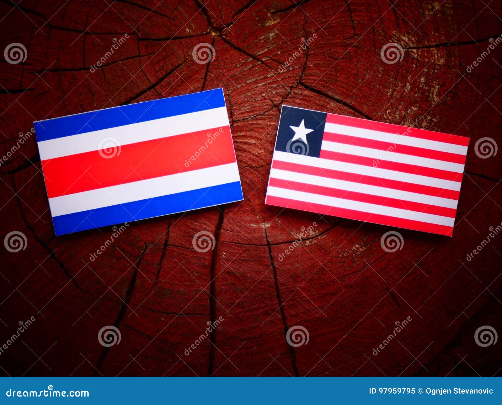 Costa Rican Flag with Liberian Flag on a Tree Stump Isolated Stock