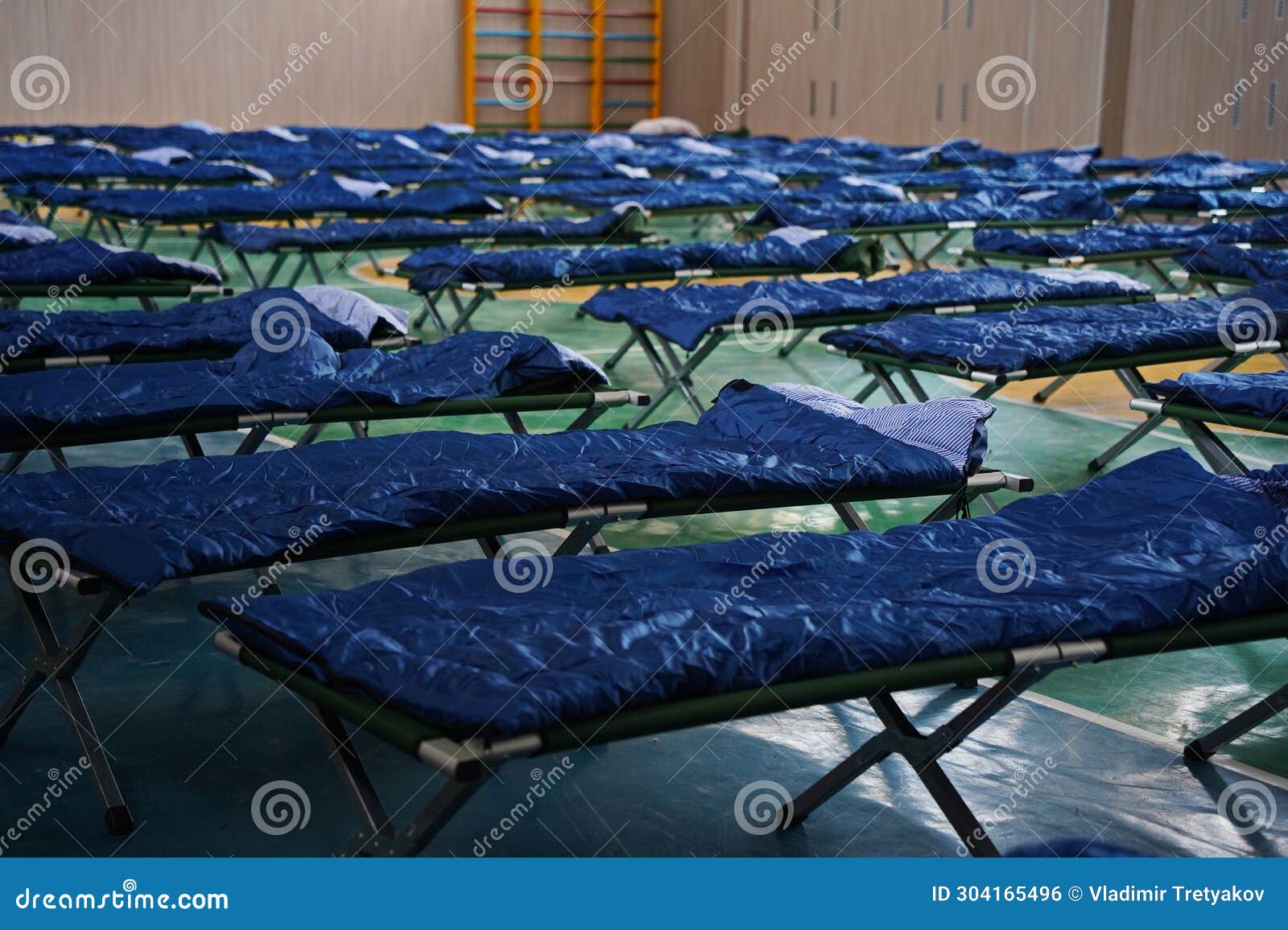 Cots with Sleeping Bags are Placed in the School Gym during an