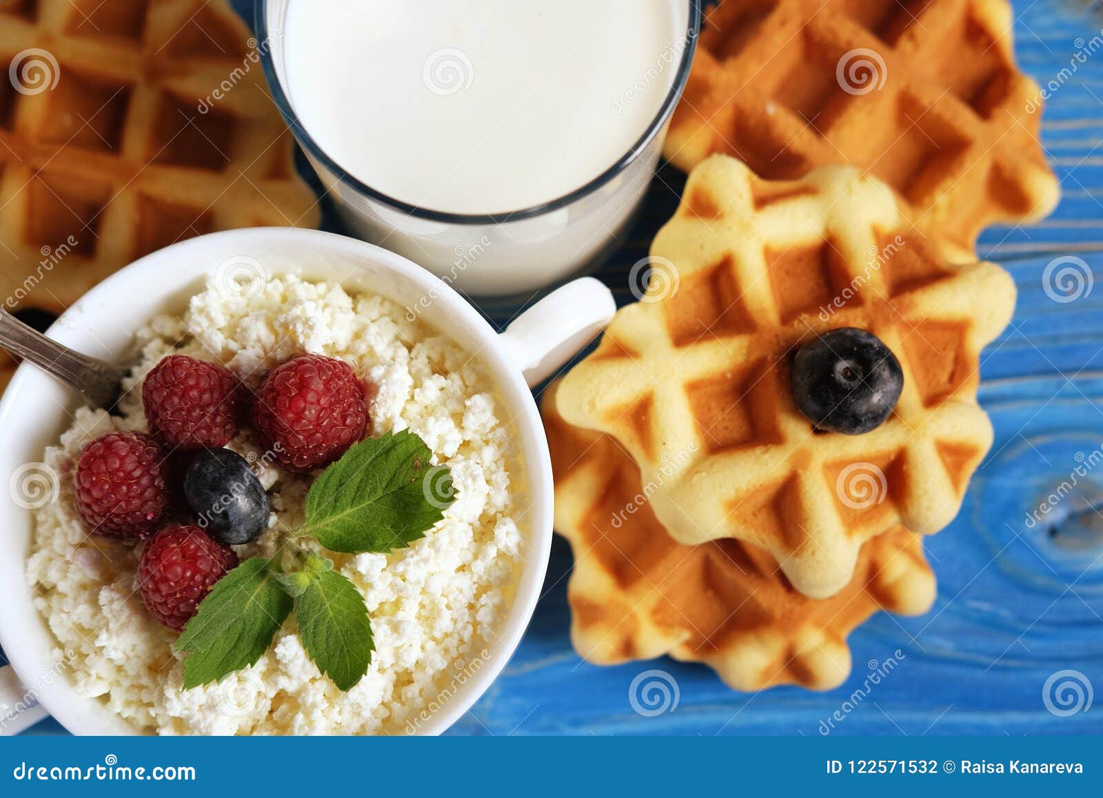Cottage Cheese With Berries Waffles And Milk On A Wooden Blue