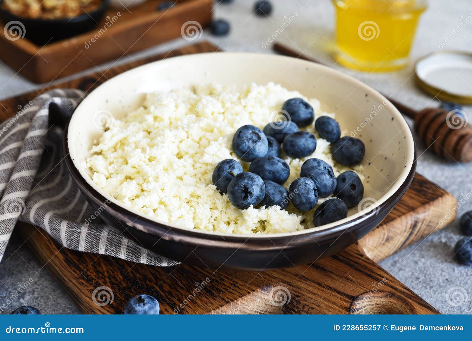 Cottage Cheese with Honey and Berries for Breakfast. Granola with