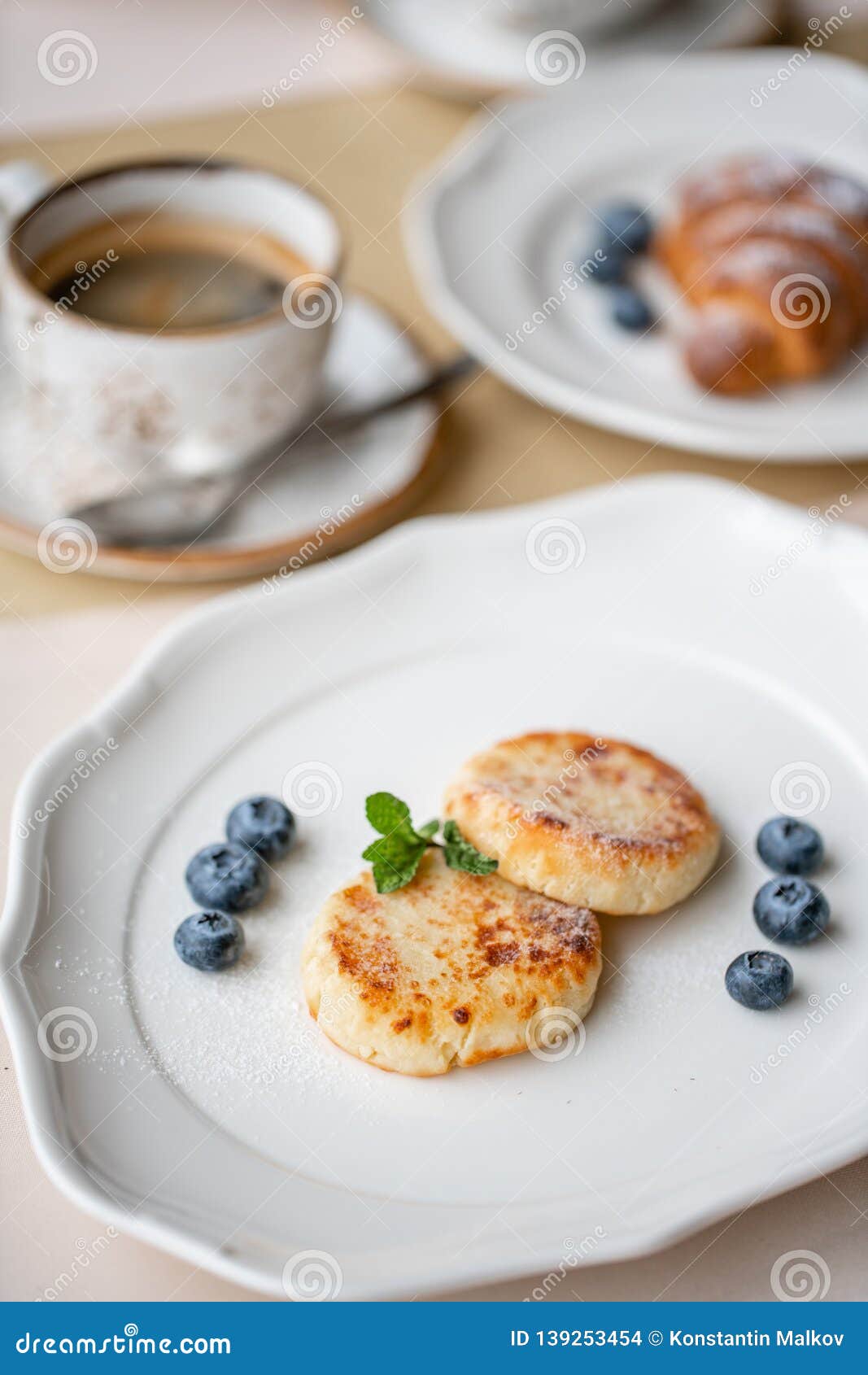 Cottage Cheese Pancakes Or Syrniki With Blueberry On White Plate
