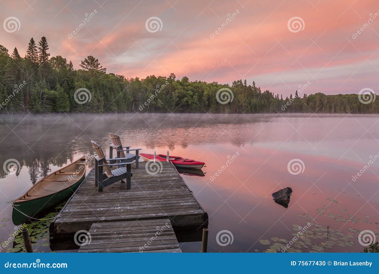 cottage dock on a canadian lake at dawn at dawn