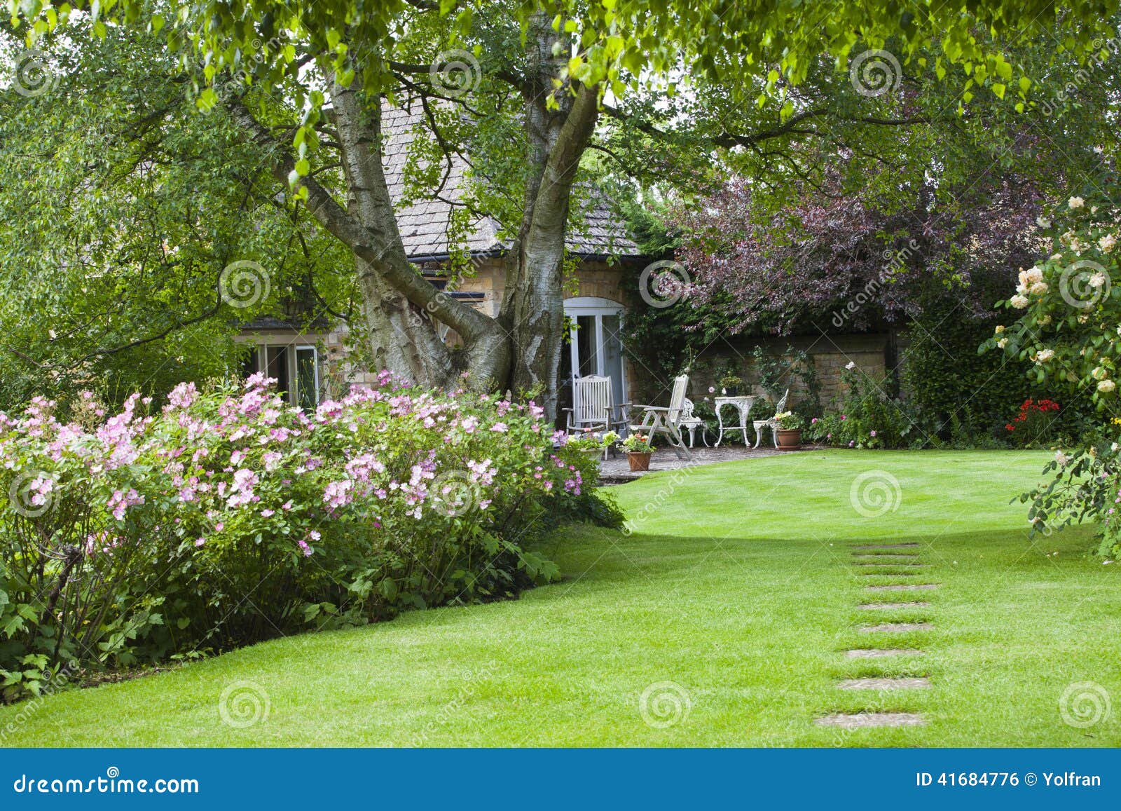 flowering cottage garden and patio on hot summer d