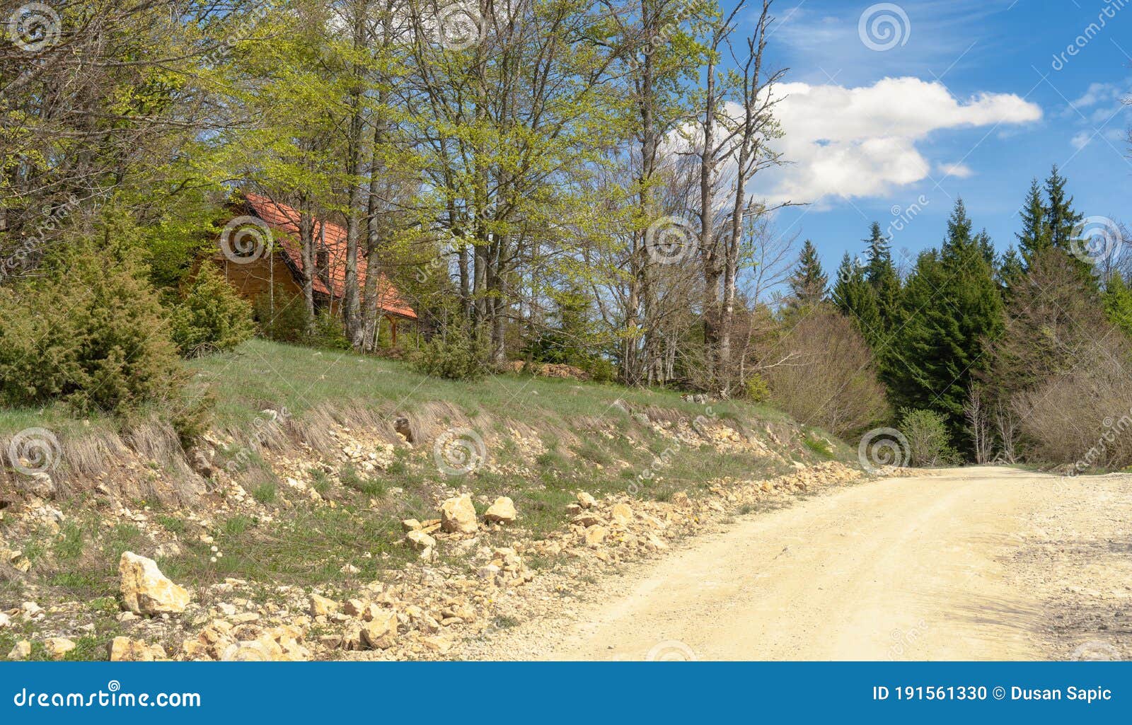 a cottage near the unpaved road.village scenary image.
