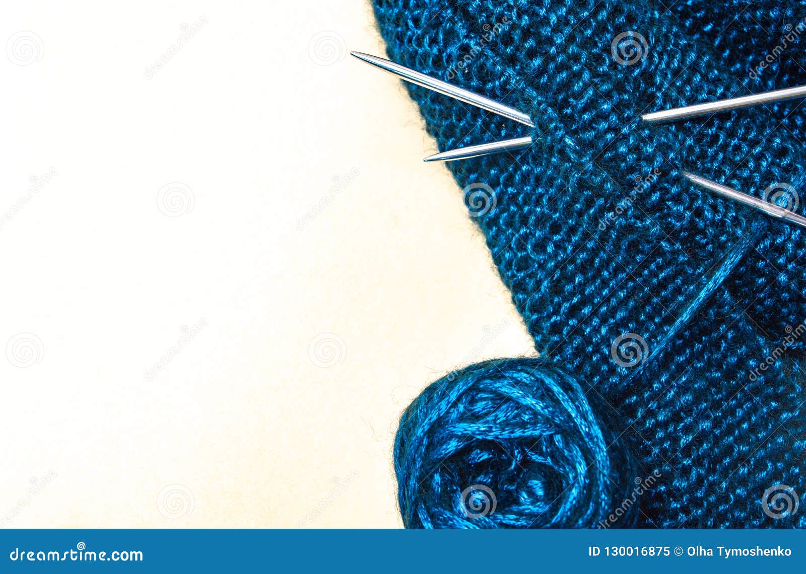 Cotton Thread with Acrylic Knitting Needles and a Ball of Blue on a