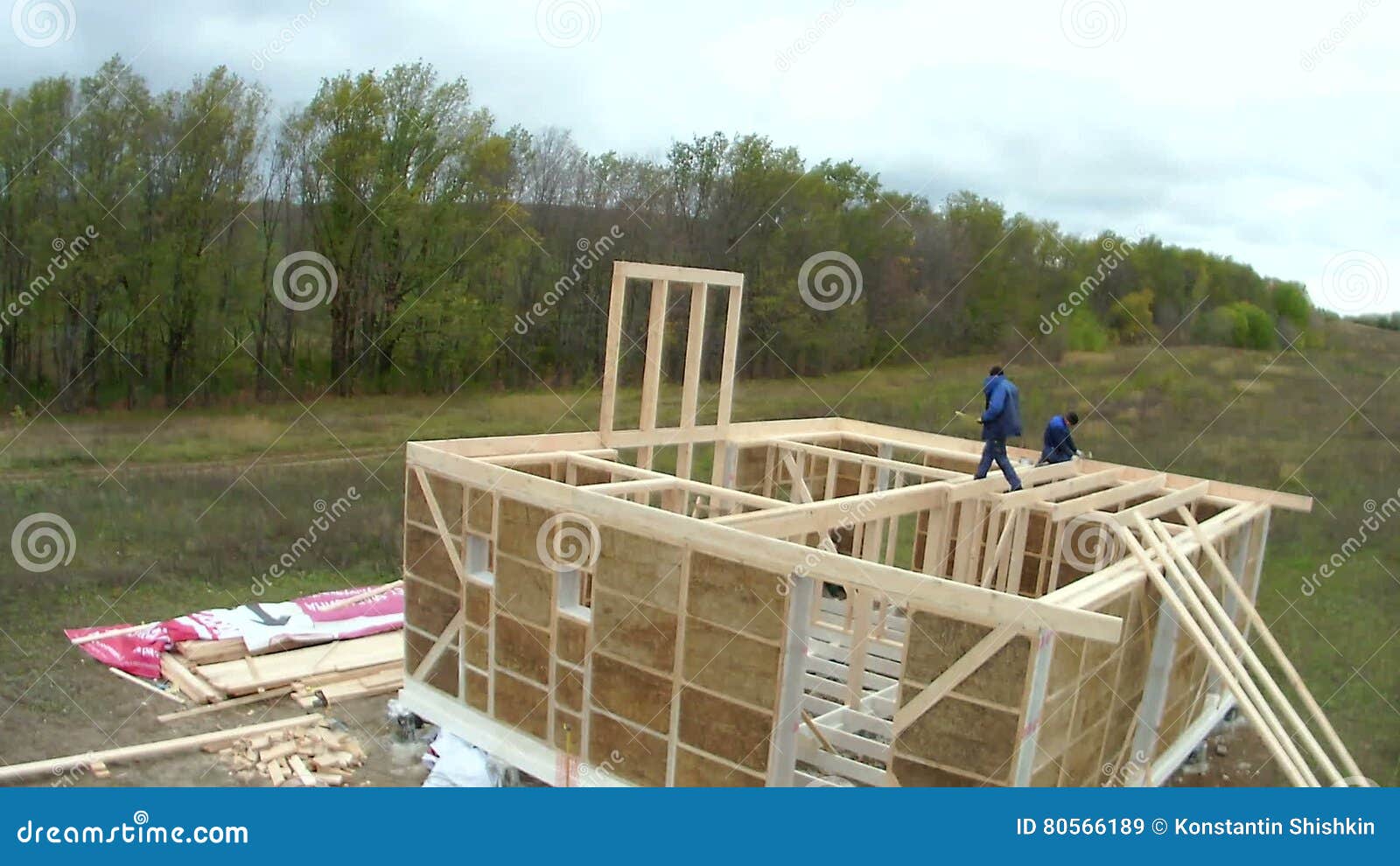 Country House of Straw Bales Construction. Workers Make the Ceiling on