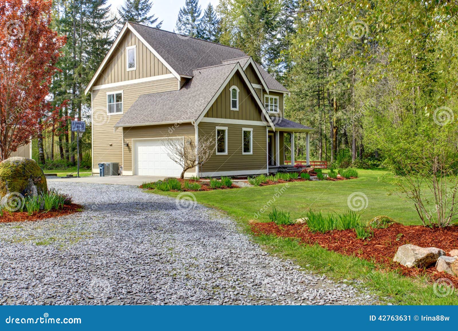 countryside house exterior. view of entrance and gravel driveway
