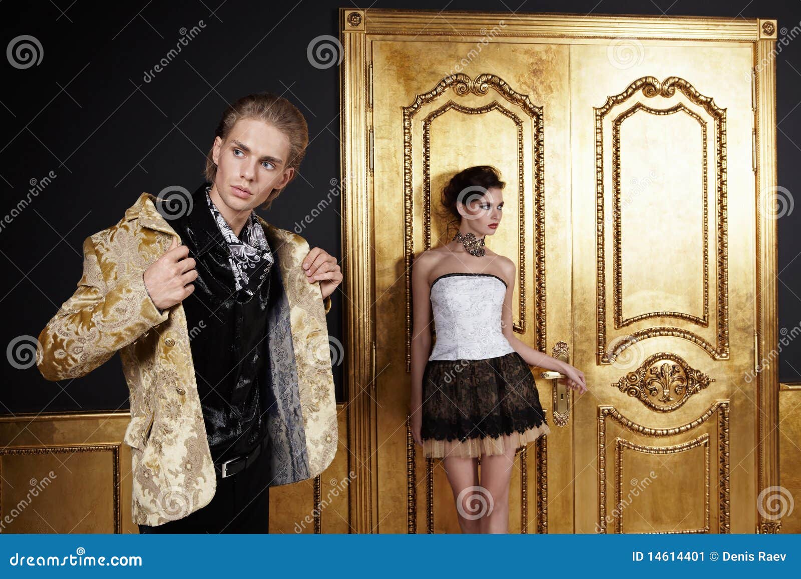 Couple. The young man puts on, the girl costs at a door