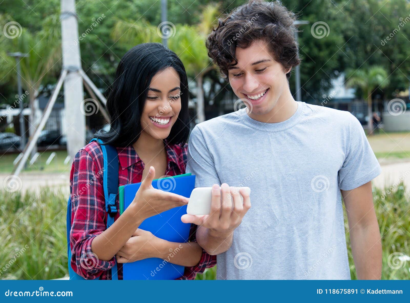 couple aof young adults watching movie on mobile phone