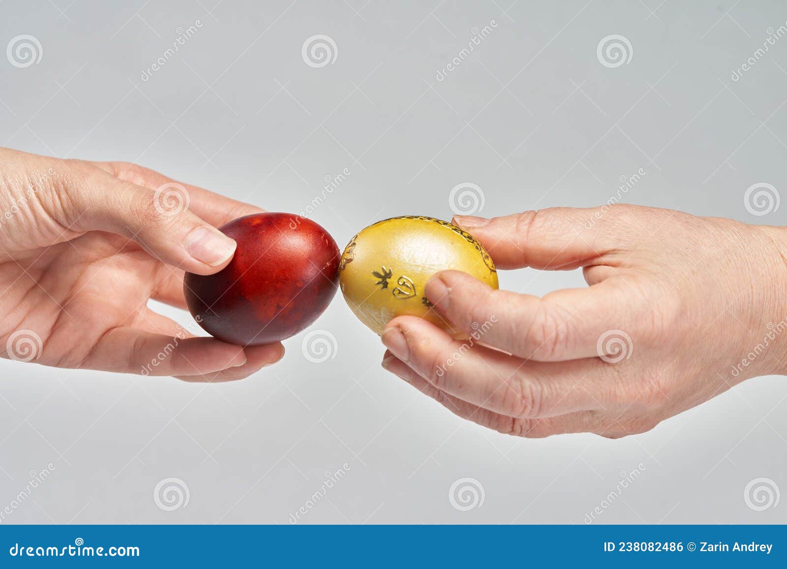 A Couple Beats Easter Eggs during the Celebration Stock Photo Image