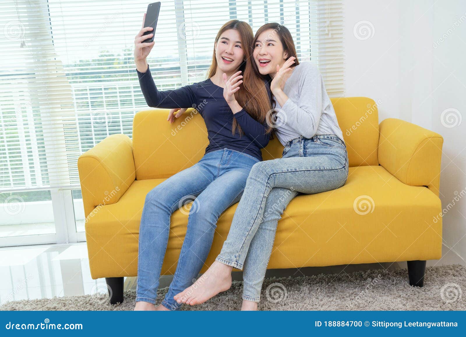 A Couple of Beautiful Asian Woman Take Photo while Smiling, Same Sex Young Married Female Couple in Their daily Routine Showing Stock Photo picture