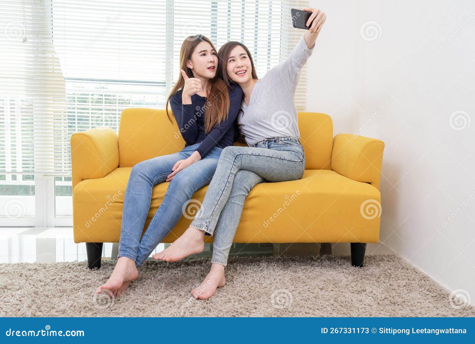 A Couple of Beautiful Asian Woman Take Photo while Smiling, Same Sex Young Married Female Couple in Their daily Routine Showing Stock Image image