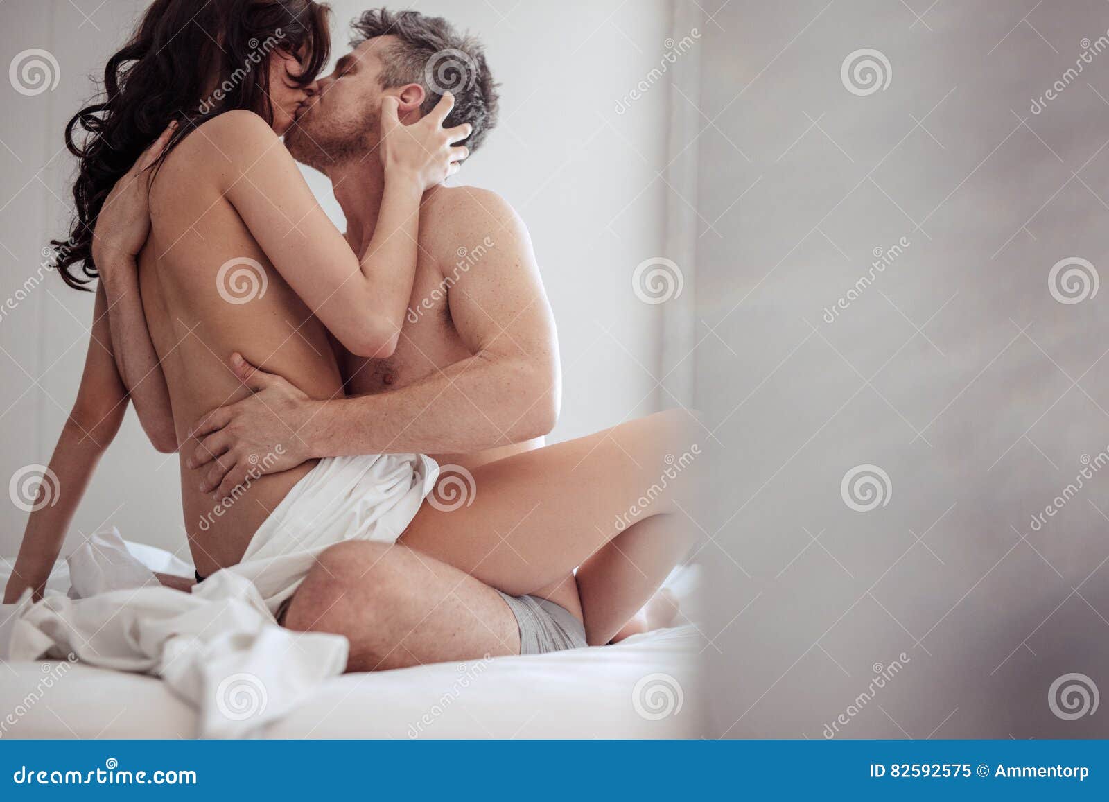 Couple in Bed Having Passionate Sex Stock Image