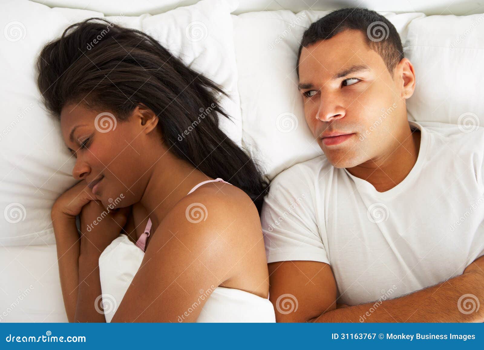 couple in bed with relationship difficulties