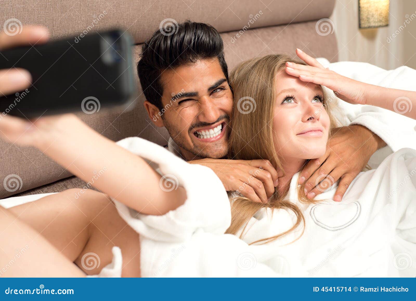 Couple In Bed Taking A Selfie And Having Fun Couple In