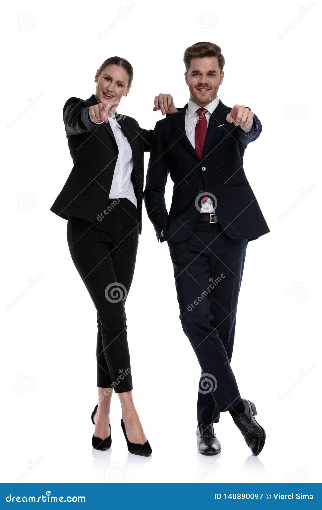 couple in business suits pointing