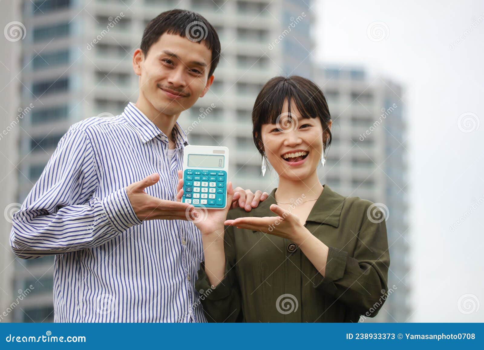 A couple with a calculator stock image. Image of couple 238933373