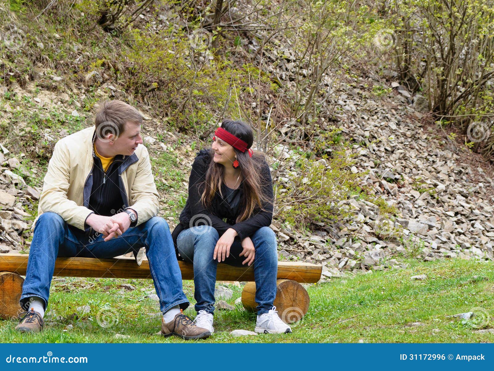 Couple Chatting Outdoors Sitting On Royalty Free Stock