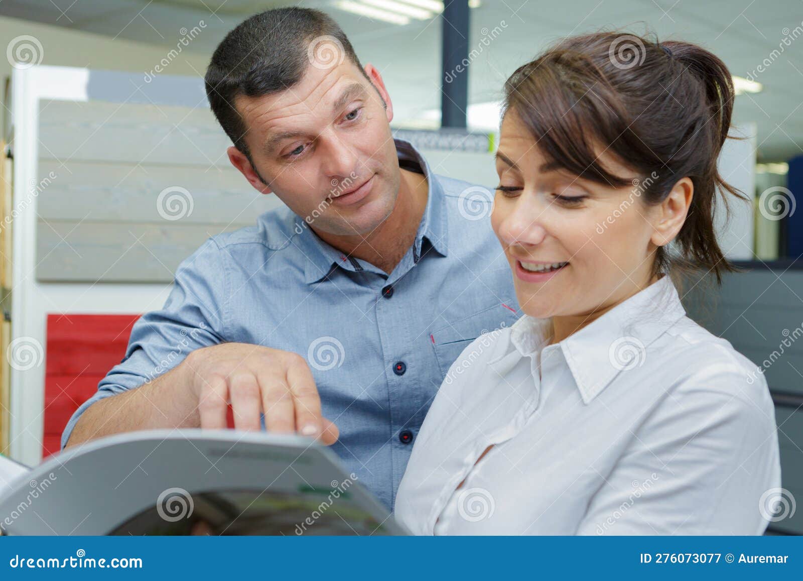 Couple Choosing Kitchen Furniture and Getting Quotation Stock Image