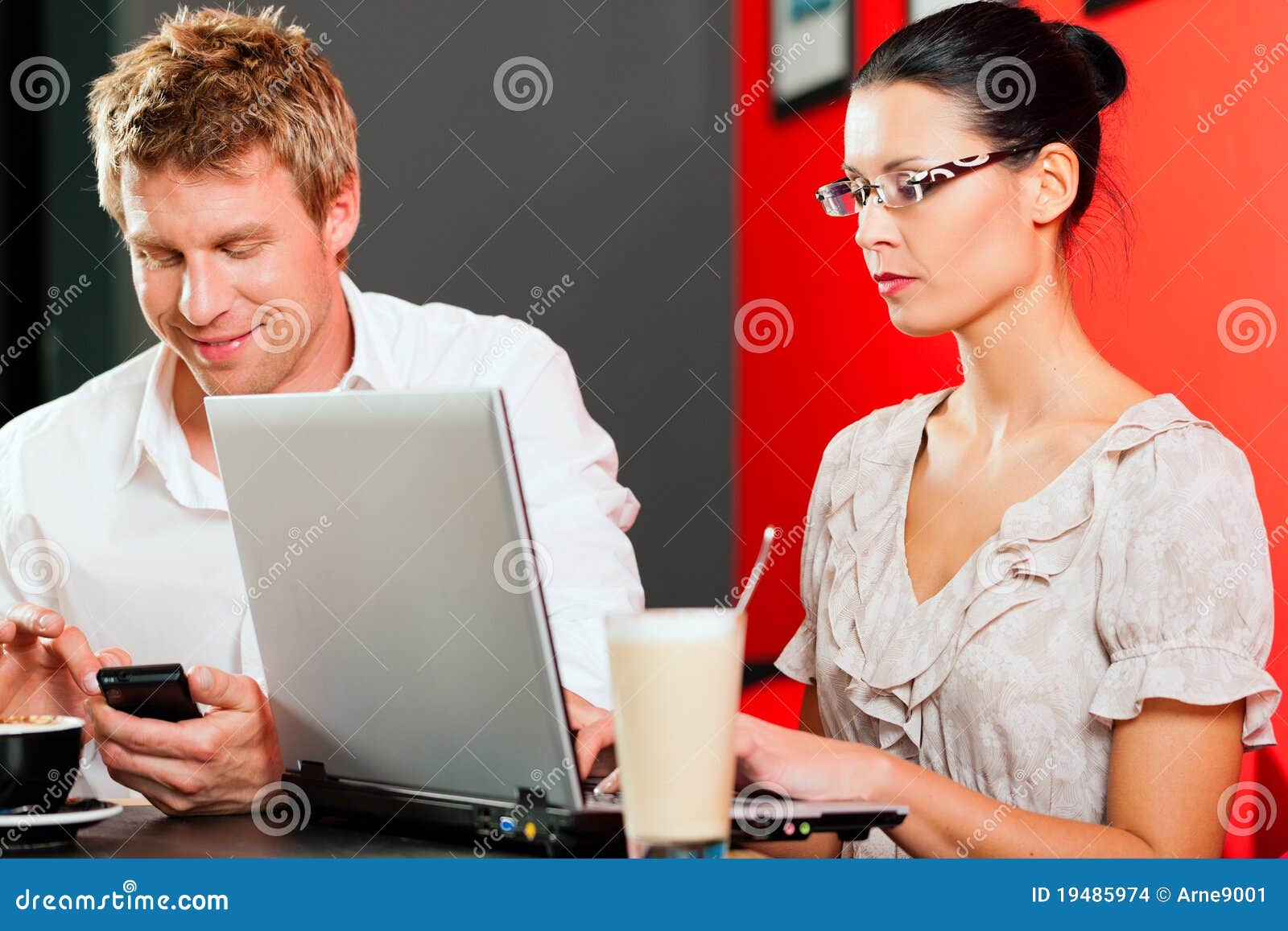 couple in coffeeshop with laptop and mobile