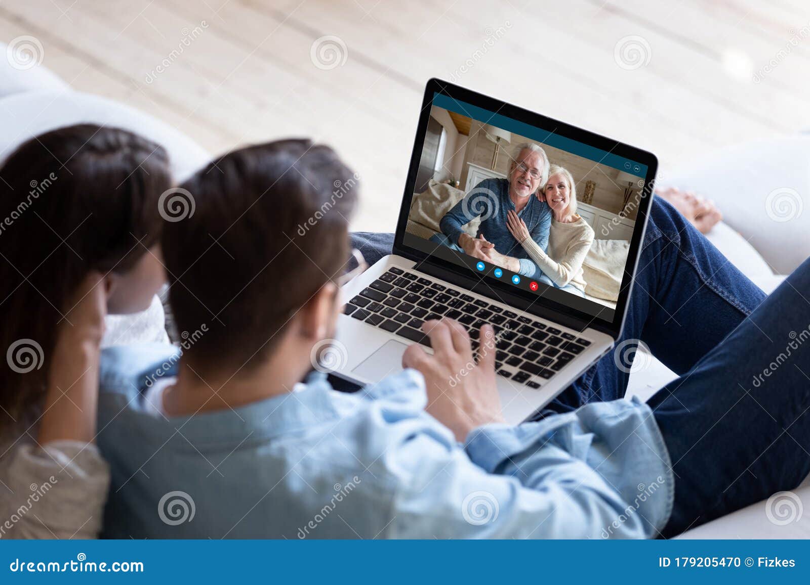 couple communicating with elderly parents using laptop and videocall app