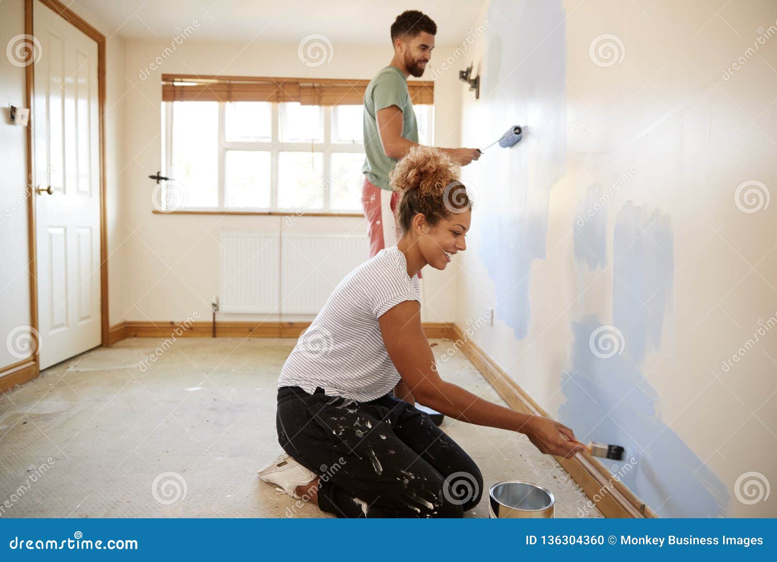 Couple Decorating Room in New Home Painting Wall Together Stock ...