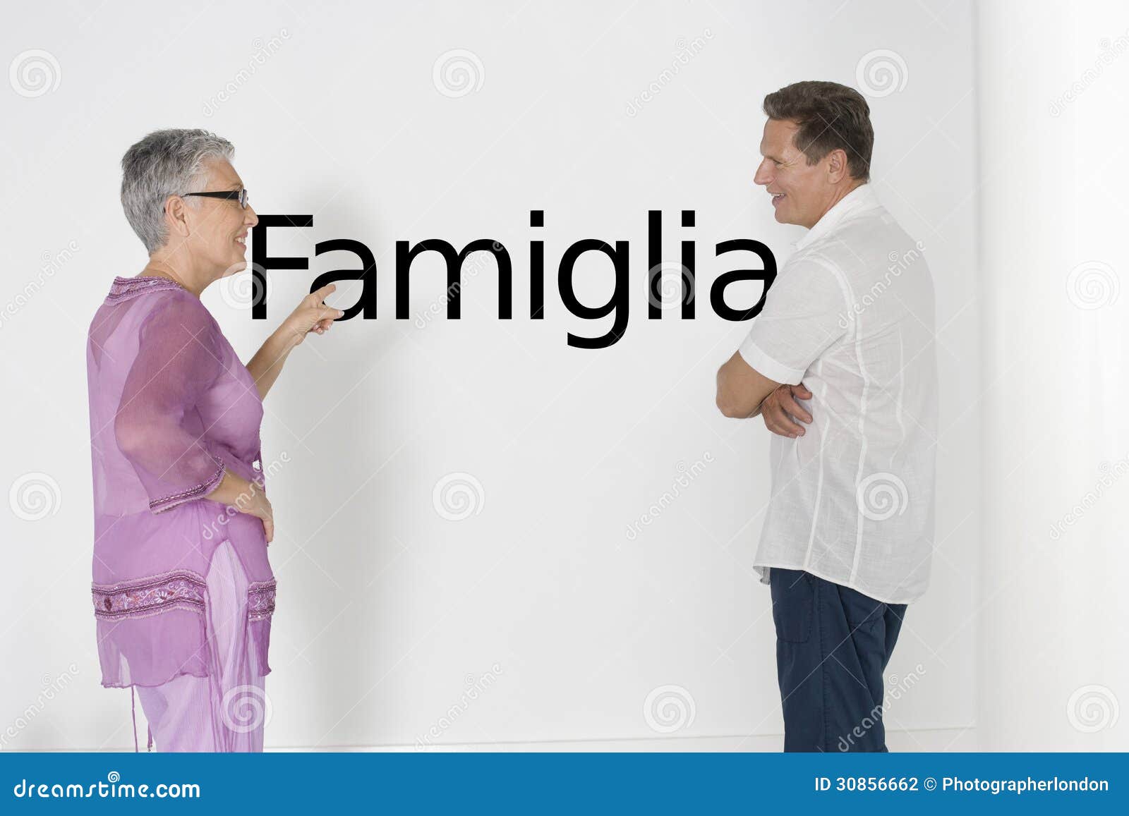 couple discussing family issues against white wall with italian text famiglia