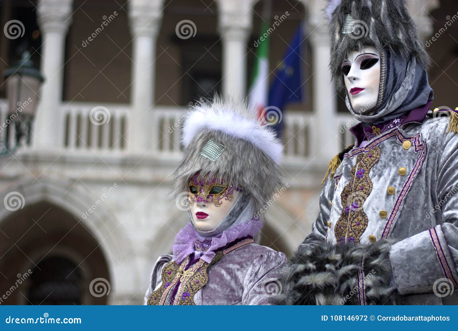 a couple disguised in elegant gray. One of the most beautiful carnivals in the world in the city, Venice, the most beautiful in the world